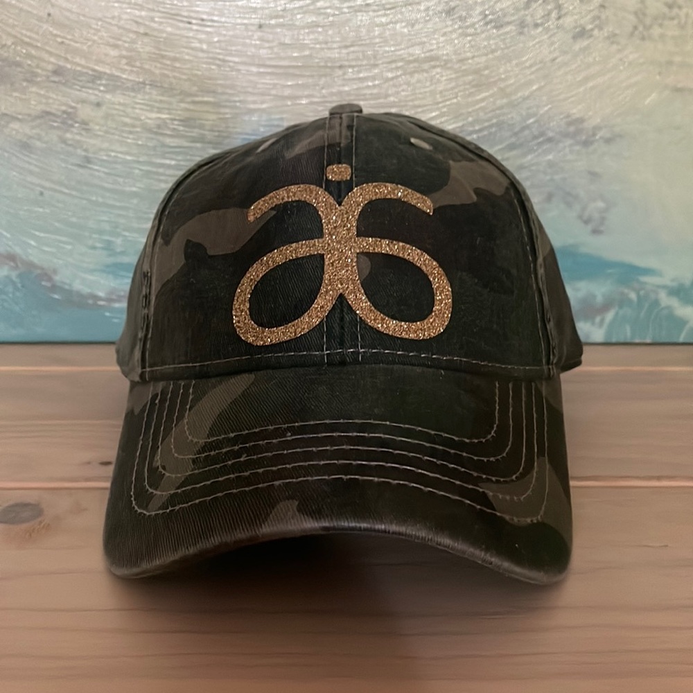 ARBONNE logo’d camouflage hat green and gold NWT
